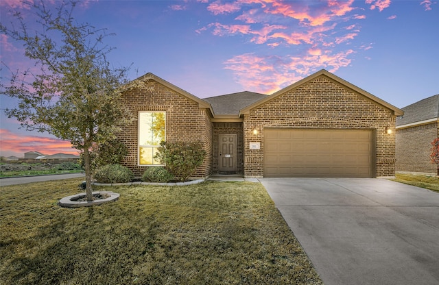 view of front of home featuring a garage and a yard