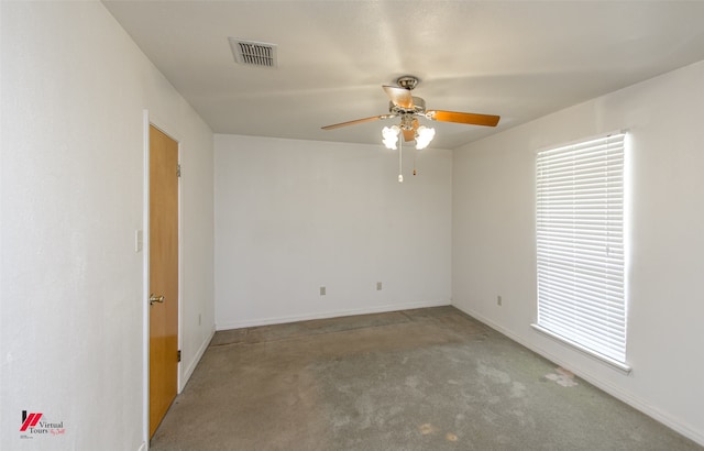 carpeted empty room featuring baseboards, visible vents, and ceiling fan