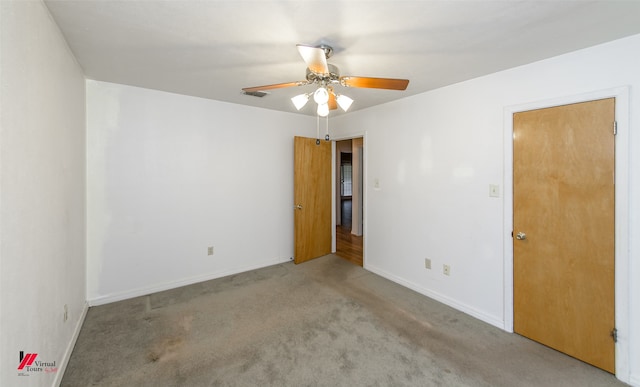 empty room featuring ceiling fan and carpet floors