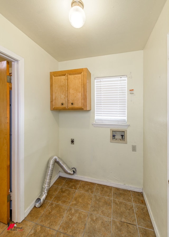 laundry area featuring tile floors, washer hookup, electric dryer hookup, and cabinets