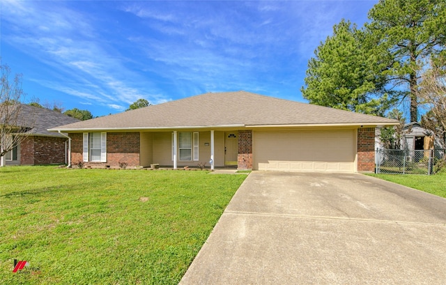 single story home featuring brick siding, a front lawn, fence, a garage, and driveway