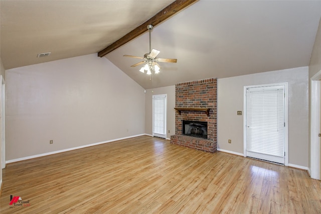 unfurnished living room featuring brick wall, a fireplace, ceiling fan, and light hardwood / wood-style flooring