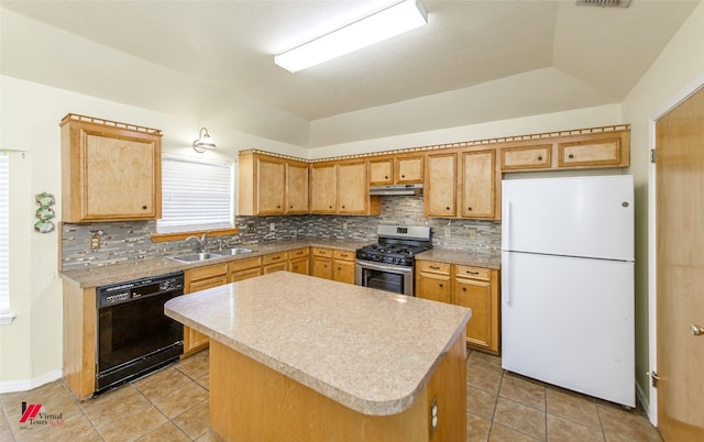 kitchen with gas stove, freestanding refrigerator, a sink, black dishwasher, and under cabinet range hood