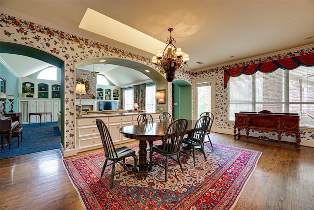 dining room with a chandelier, a wealth of natural light, and dark hardwood / wood-style flooring