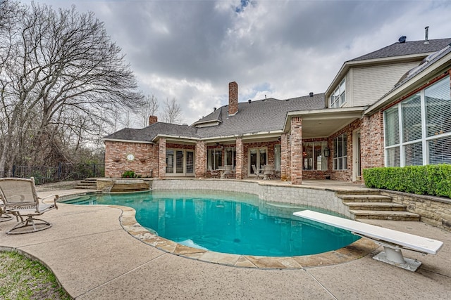 view of pool featuring a patio area and a diving board