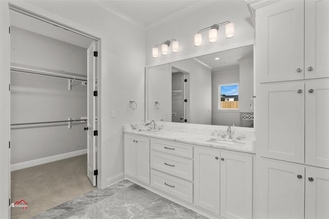 bathroom featuring dual sinks, tile flooring, crown molding, and large vanity