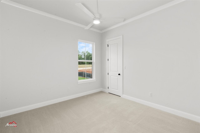 carpeted empty room featuring crown molding and ceiling fan