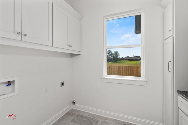 laundry room with tile floors, cabinets, electric dryer hookup, and hookup for a washing machine