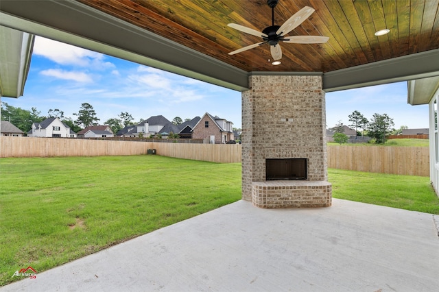 view of terrace with an outdoor brick fireplace and ceiling fan