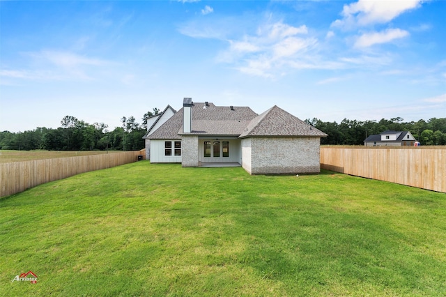 back of property featuring a lawn