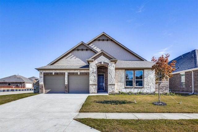 craftsman house with a front lawn and a garage