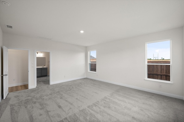 carpeted empty room featuring a healthy amount of sunlight