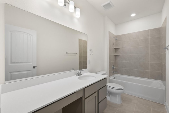 full bathroom with tile patterned floors, tiled shower / bath combo, toilet, and vanity