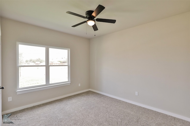 carpeted spare room with ceiling fan