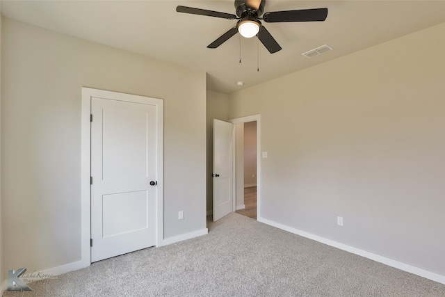 unfurnished bedroom with ceiling fan and light carpet