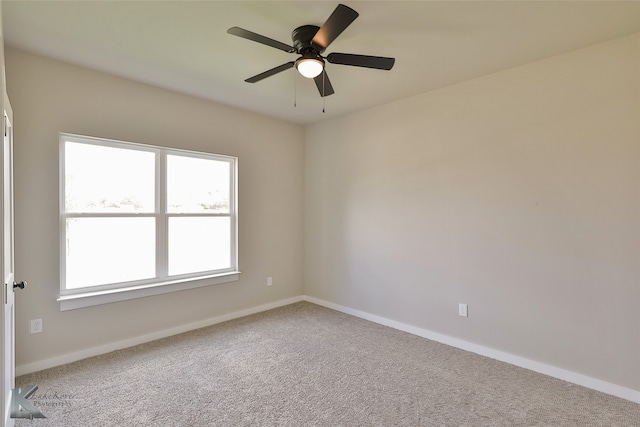 carpeted spare room with ceiling fan