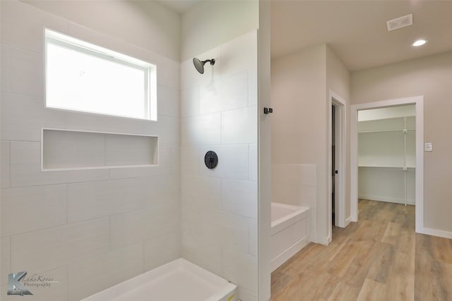 bathroom featuring hardwood / wood-style flooring and separate shower and tub