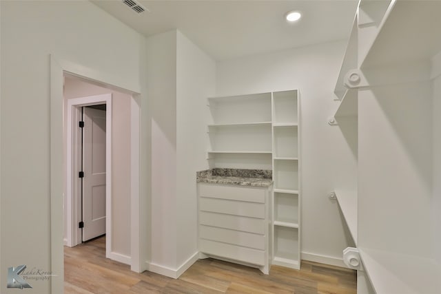 spacious closet with light hardwood / wood-style floors