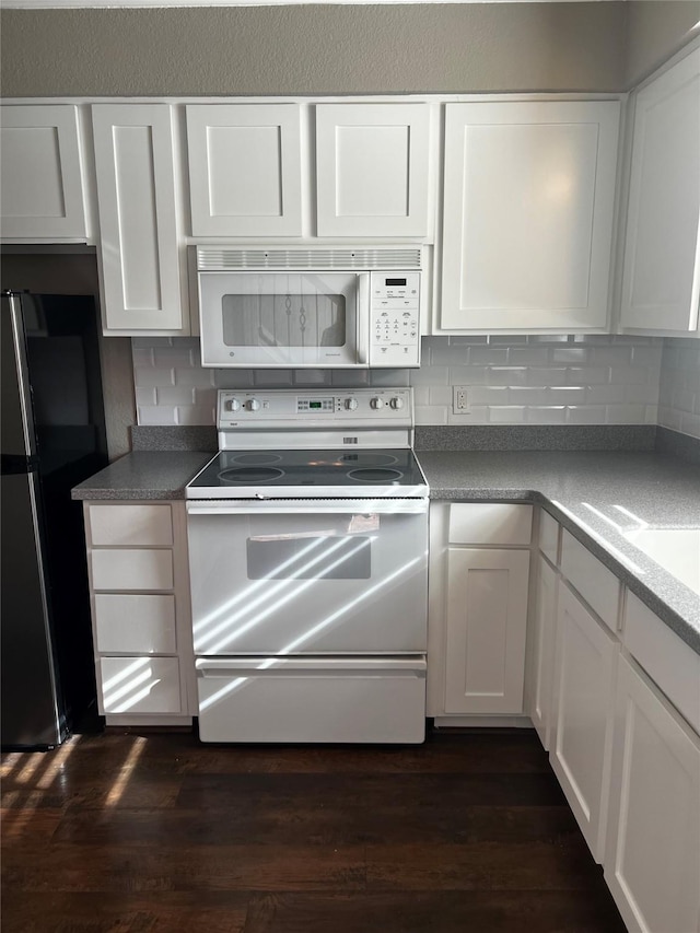 kitchen with tasteful backsplash, white cabinets, white appliances, and dark wood finished floors