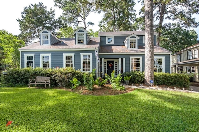 rear view of house featuring a yard