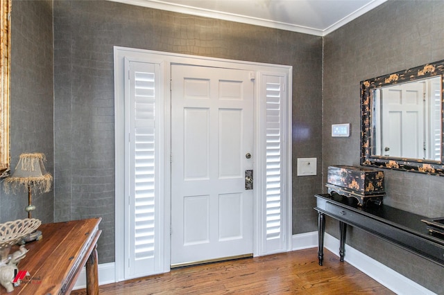 entrance foyer featuring baseboards, wood finished floors, and crown molding