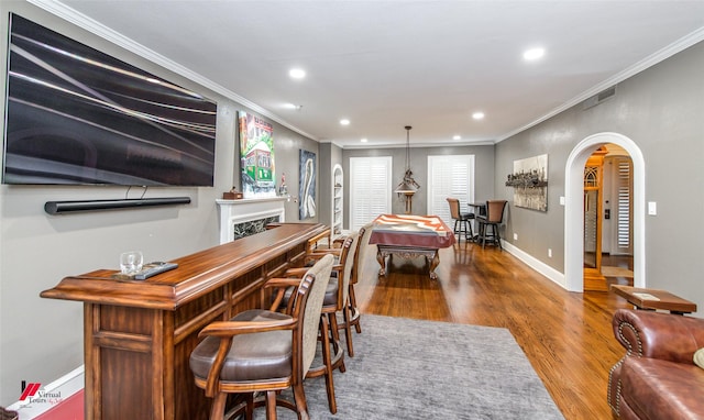 dining room featuring baseboards, visible vents, arched walkways, wood finished floors, and recessed lighting