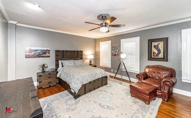 bedroom featuring ornamental molding, baseboards, and wood finished floors