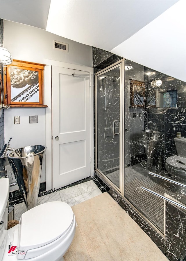 bathroom featuring a stall shower, marble finish floor, visible vents, and toilet