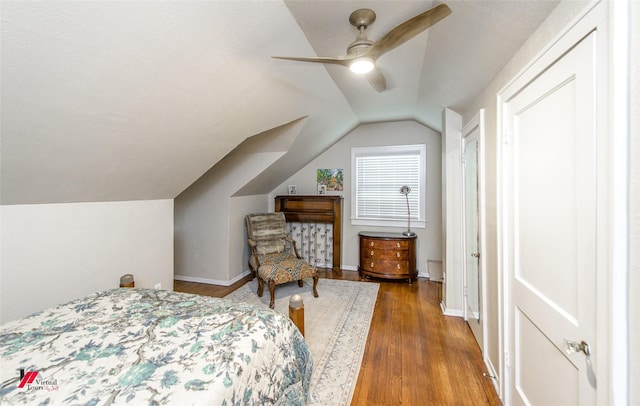 bedroom featuring lofted ceiling, ceiling fan, baseboards, and wood finished floors