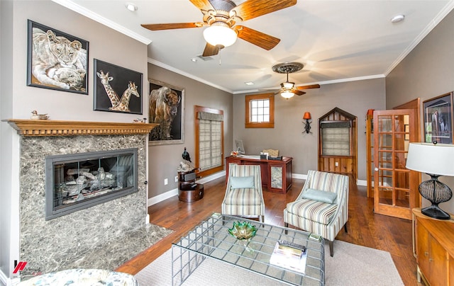 living room featuring wood-type flooring, a high end fireplace, and crown molding