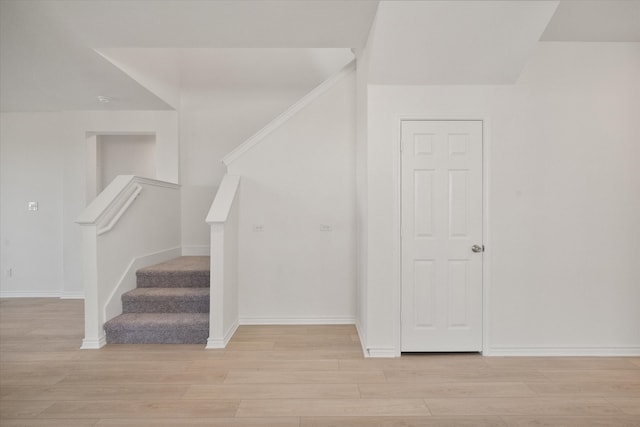 stairs with hardwood / wood-style floors