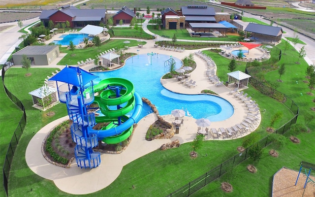 view of pool featuring a water slide and a patio