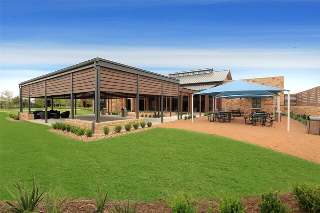 back of house with a lawn and a gazebo