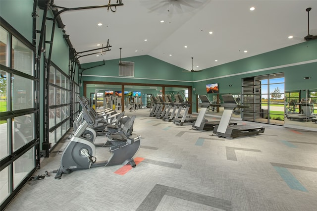 exercise room with light carpet and high vaulted ceiling