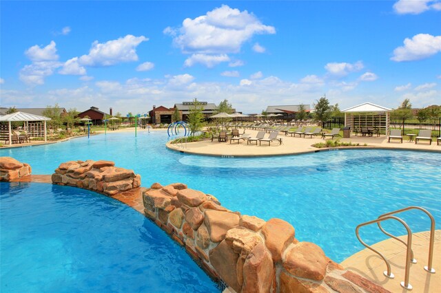 view of pool with pool water feature and a gazebo