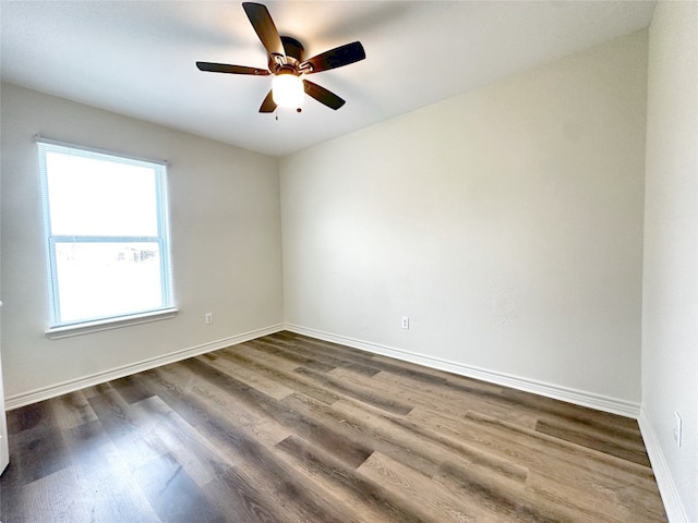 spare room featuring ceiling fan and dark hardwood / wood-style flooring