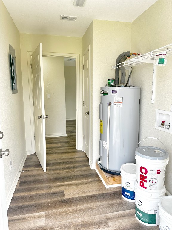 utility room featuring water heater