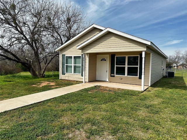 bungalow-style home featuring central AC unit and a front lawn