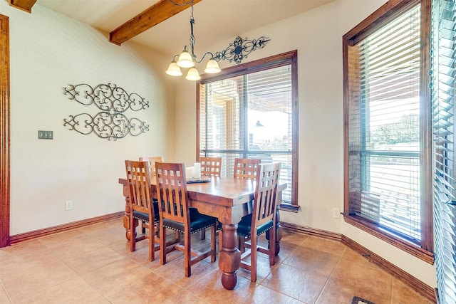 dining room with an inviting chandelier, beam ceiling, and light tile patterned floors