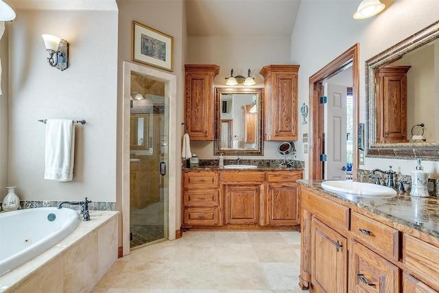 bathroom with vanity and independent shower and bath