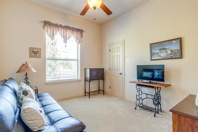 carpeted living room with ceiling fan