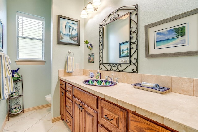 bathroom with tile patterned flooring, vanity, and toilet