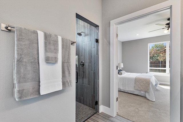 bathroom featuring walk in shower and ceiling fan