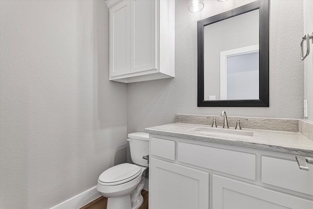 bathroom featuring vanity, toilet, and wood-type flooring