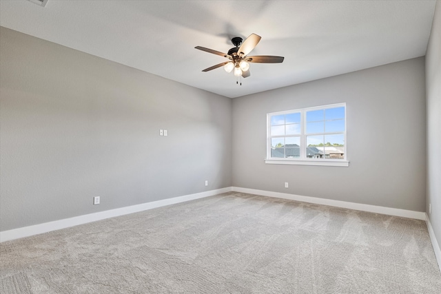 empty room with ceiling fan and carpet flooring