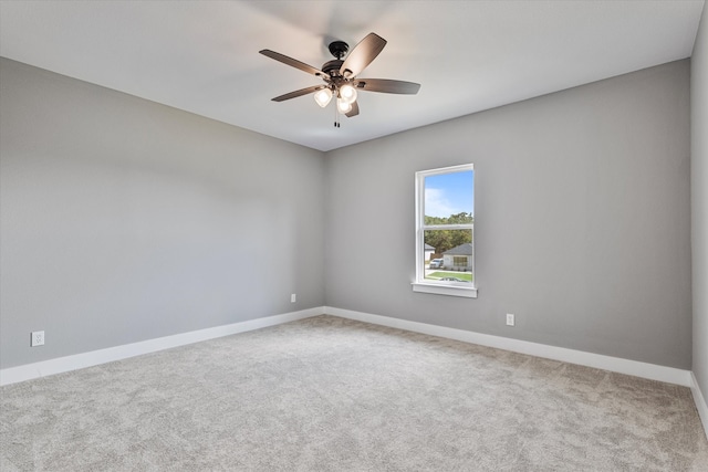 spare room featuring ceiling fan and carpet floors