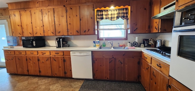 kitchen featuring white appliances, light tile flooring, and sink