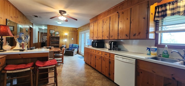 kitchen with dishwasher, sink, light tile floors, and ceiling fan