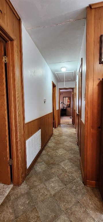 hallway featuring dark tile floors