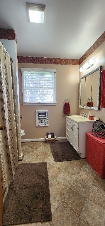 bathroom with vanity, tile floors, and toilet